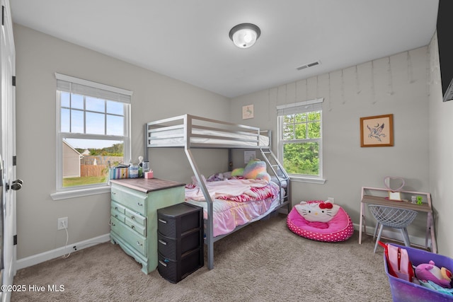 carpeted bedroom with baseboards and visible vents