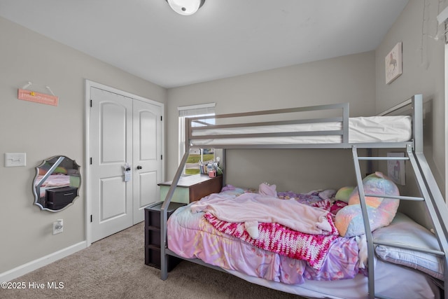 bedroom featuring baseboards, carpet, and a closet