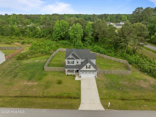 birds eye view of property with a wooded view
