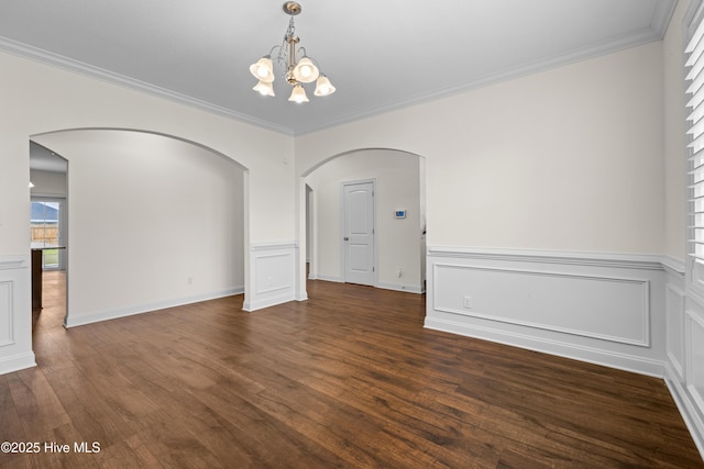 unfurnished dining area with arched walkways, ornamental molding, dark wood-style flooring, and a notable chandelier
