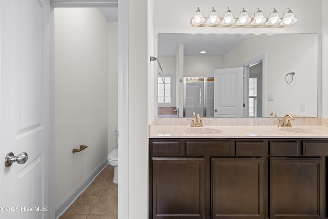 full bathroom featuring double vanity, a sink, tile patterned floors, and a stall shower