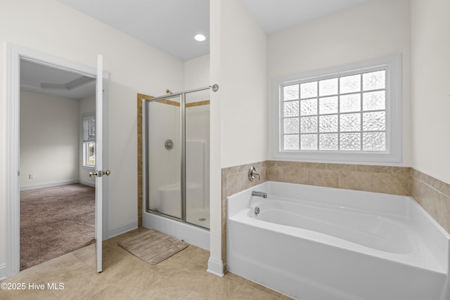 bathroom featuring a garden tub, tile patterned flooring, and a stall shower