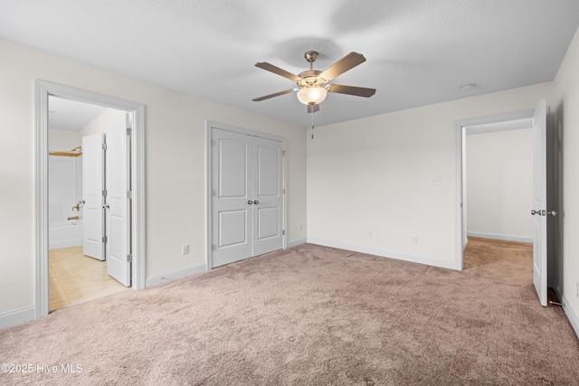 unfurnished bedroom featuring a closet, carpet flooring, and baseboards