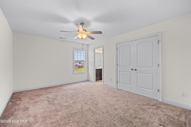 unfurnished bedroom with baseboards, carpet, and visible vents