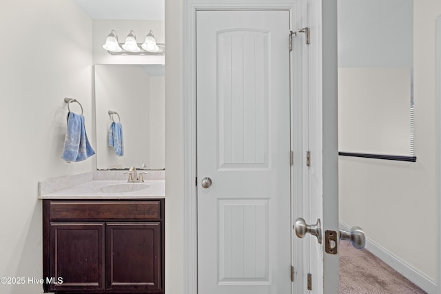 bathroom with vanity and baseboards