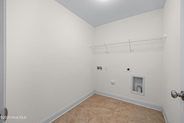 clothes washing area with laundry area, washer hookup, baseboards, hookup for a gas dryer, and hookup for an electric dryer