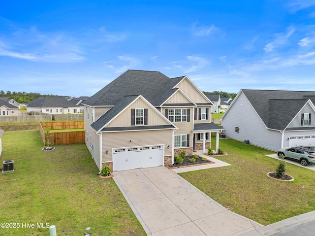 view of front of home with an attached garage, a front lawn, stone siding, board and batten siding, and concrete driveway