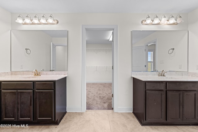 bathroom featuring a sink, tile patterned floors, and two vanities