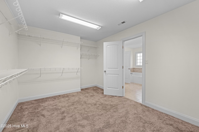 spacious closet with light carpet and visible vents