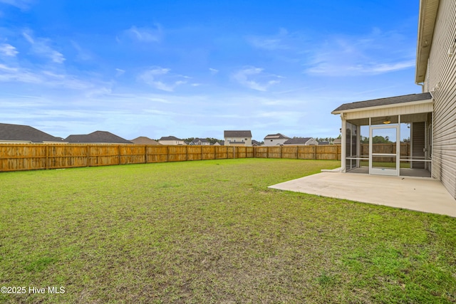 view of yard with a sunroom, a fenced backyard, ceiling fan, and a patio area