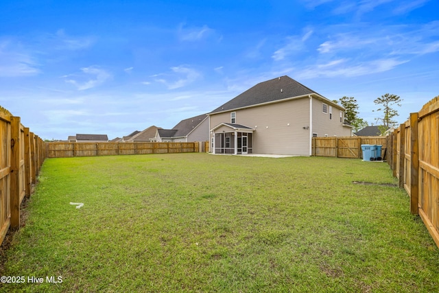 view of yard with a fenced backyard and a sunroom