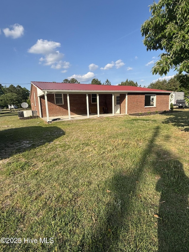 175 Molly Ave, Vanceboro, NC 28586 - rear view of house featuring brick siding and a yard