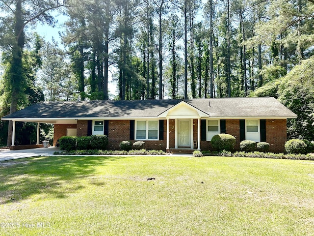 single story home featuring a carport, concrete driveway, a front yard, and brick siding