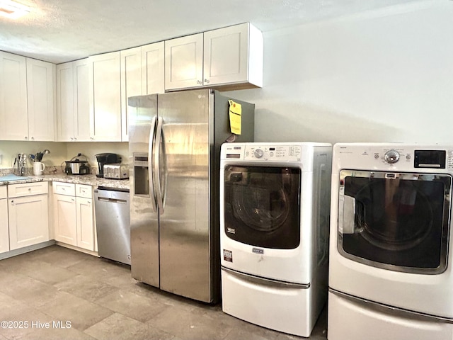 kitchen featuring wall chimney range hood, electric range, a textured ceiling, a sink, and white cabinets