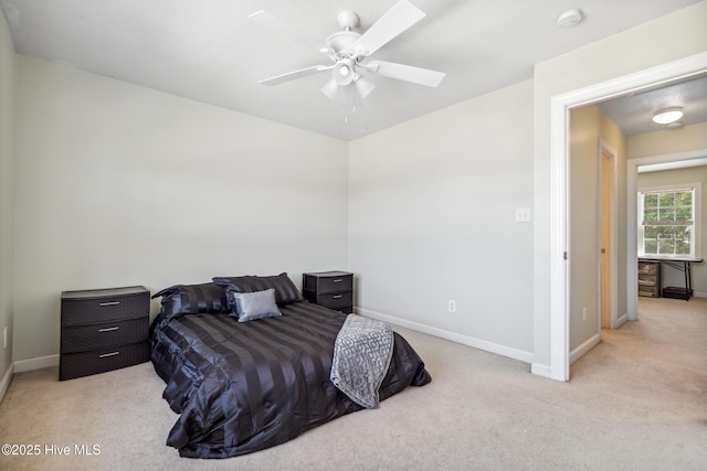 bedroom featuring baseboards, ceiling fan, and light colored carpet