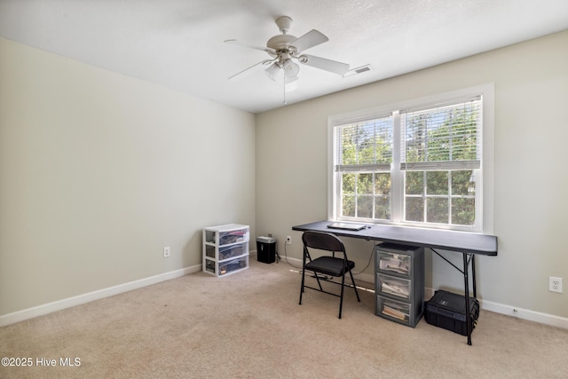 carpeted office with ceiling fan, visible vents, and baseboards