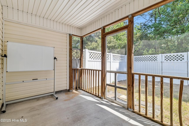 unfurnished sunroom with a wealth of natural light
