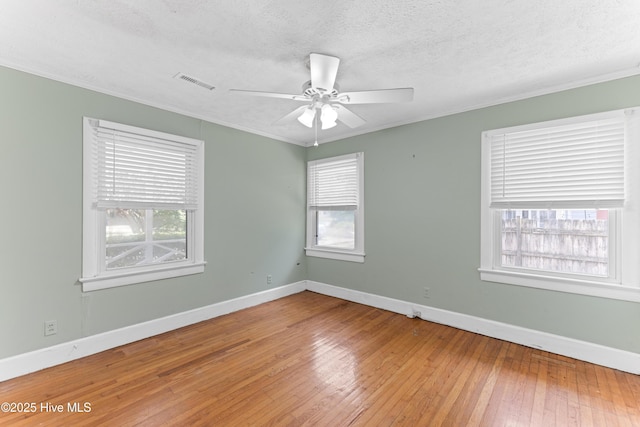 814 Latimer Dr, Wilmington, NC 28403 - empty room featuring wood-type flooring, ornamental molding, baseboards, a ceiling fan, and a textured ceiling