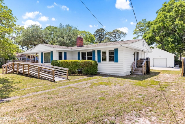 814 Latimer Dr, Wilmington, NC 28403 - single story home with a detached garage, a chimney, a front lawn, and an outbuilding