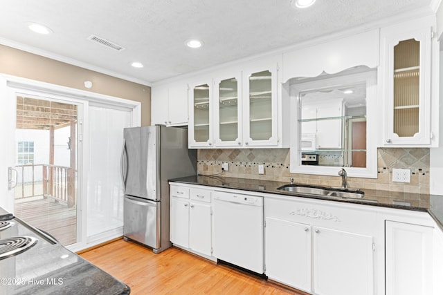 814 Latimer Dr, Wilmington, NC 28403 - kitchen featuring white appliances, a sink, light wood-style floors, white cabinetry, and crown molding