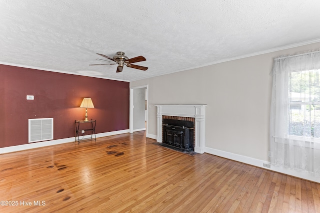 814 Latimer Dr, Wilmington, NC 28403 - unfurnished living room featuring a textured ceiling, wood-type flooring, a ceiling fan, baseboards, and a fireplace