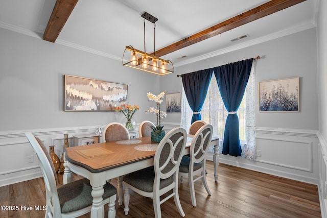 dining area featuring visible vents, wood finished floors, a notable chandelier, and beamed ceiling