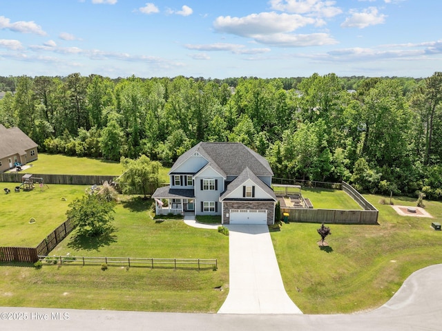 birds eye view of property with a wooded view