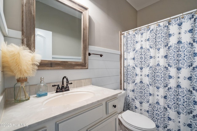 bathroom featuring vanity, toilet, and curtained shower