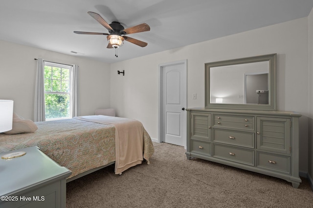 bedroom with visible vents, a ceiling fan, and carpet