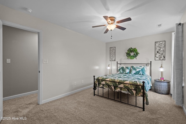 carpeted bedroom featuring baseboards, visible vents, and ceiling fan