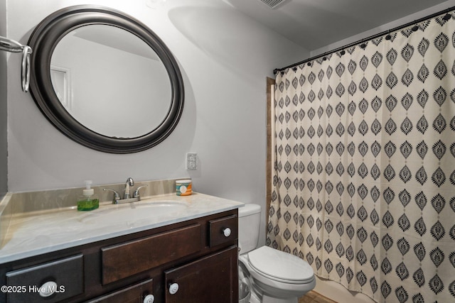 full bathroom with vanity, toilet, and curtained shower