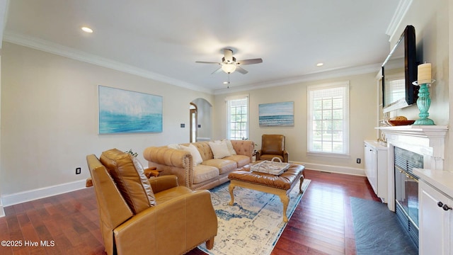living room featuring arched walkways, ceiling fan, baseboards, and dark wood-style floors