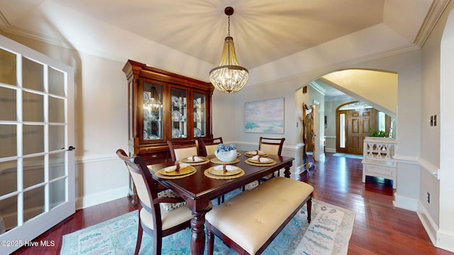 dining area with an inviting chandelier, arched walkways, baseboards, and hardwood / wood-style floors
