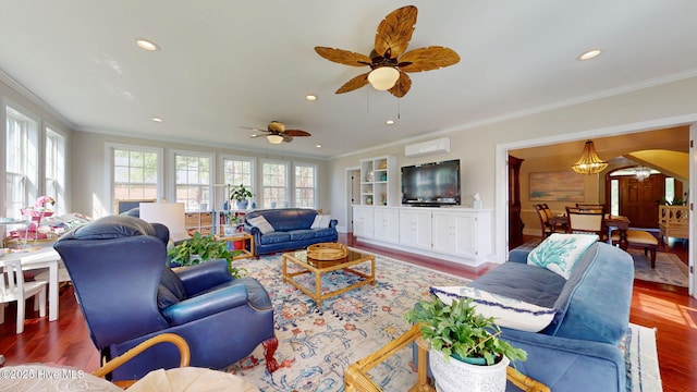 living room featuring crown molding, a ceiling fan, arched walkways, and wood finished floors