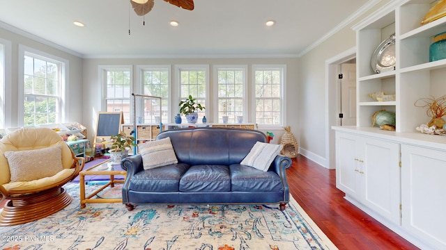 living room featuring crown molding, dark wood-style flooring, baseboards, recessed lighting, and a ceiling fan
