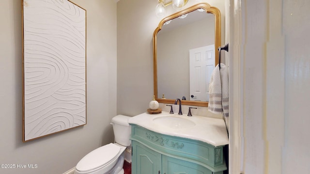 half bath with vanity and toilet