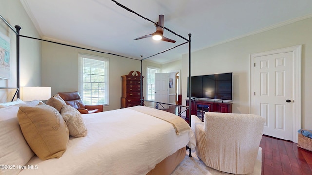 bedroom with wood-type flooring, a ceiling fan, and crown molding