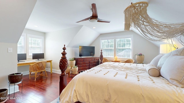 bedroom featuring baseboards, wood finished floors, vaulted ceiling, and multiple windows