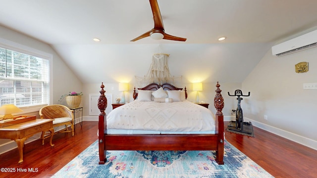 bedroom featuring wood finished floors, baseboards, a wall mounted air conditioner, and lofted ceiling