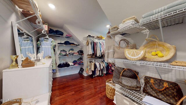 spacious closet with vaulted ceiling and hardwood / wood-style floors