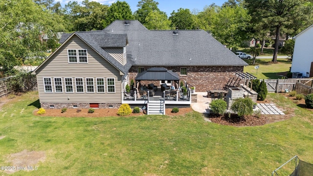 back of property featuring a gazebo, a yard, and crawl space