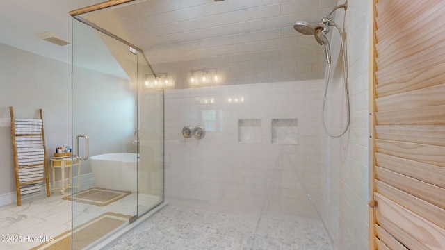 full bath featuring a soaking tub and a stall shower