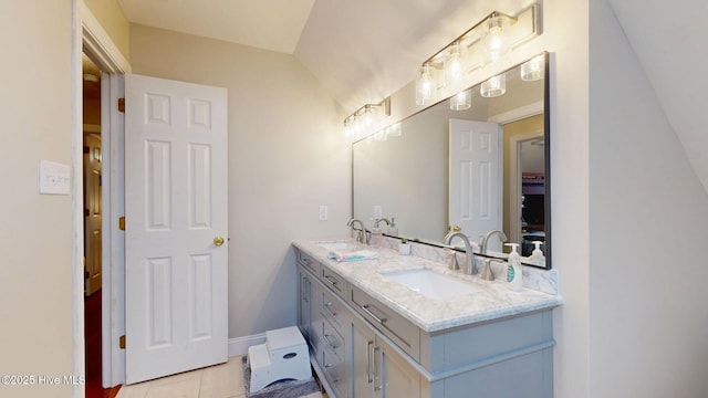 full bath featuring double vanity, a sink, and tile patterned floors