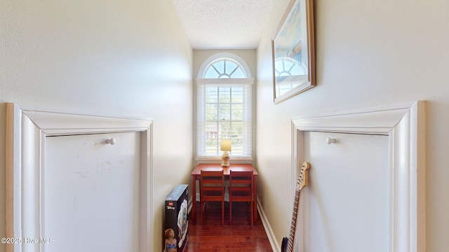 details featuring a textured ceiling, heating unit, and wood finished floors