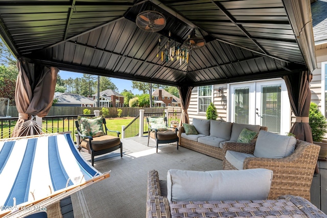 view of patio featuring a fenced backyard, french doors, an outdoor hangout area, a ceiling fan, and a gazebo