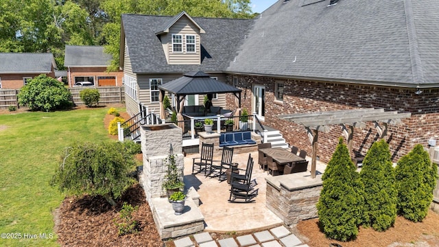exterior space with a gazebo, a fenced backyard, a patio area, and a yard