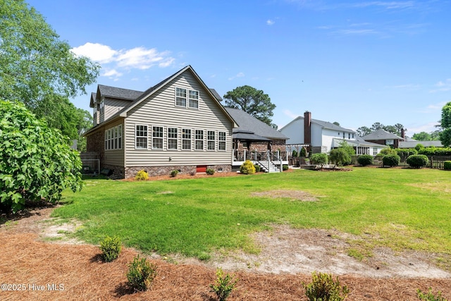 back of house featuring a gazebo, a lawn, and fence