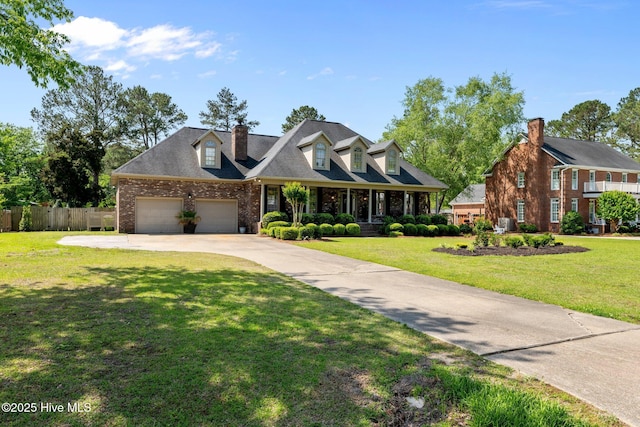 new england style home with concrete driveway, brick siding, fence, and a front lawn