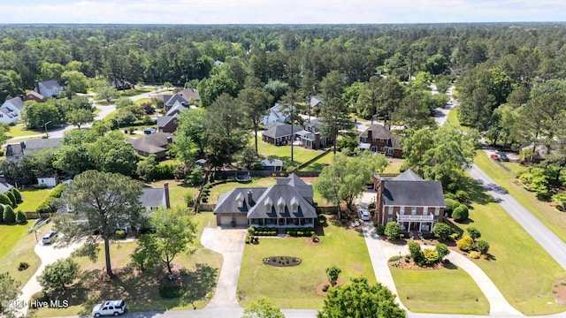 drone / aerial view featuring a view of trees and a residential view