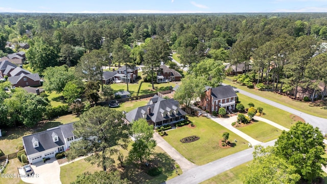 drone / aerial view with a residential view and a wooded view